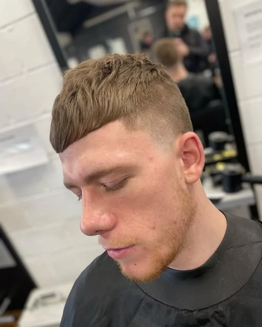 Short textured haircut with a precise cropped fringe